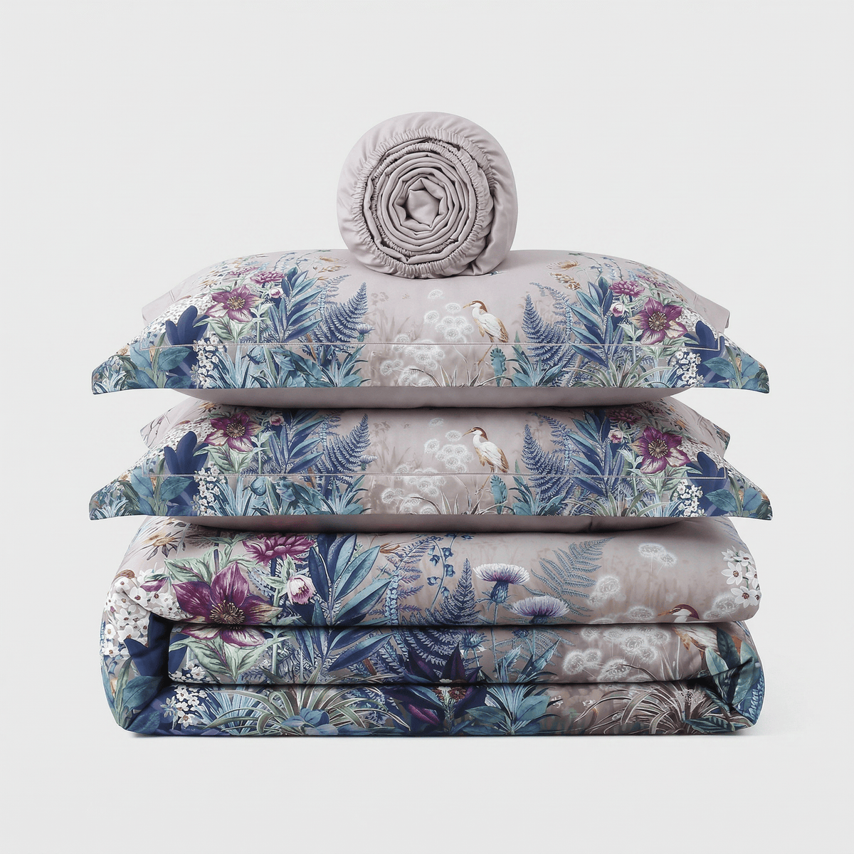 Purple Flowers bedding set, folded: duvet cover, two pillowcases and a rolled sheet